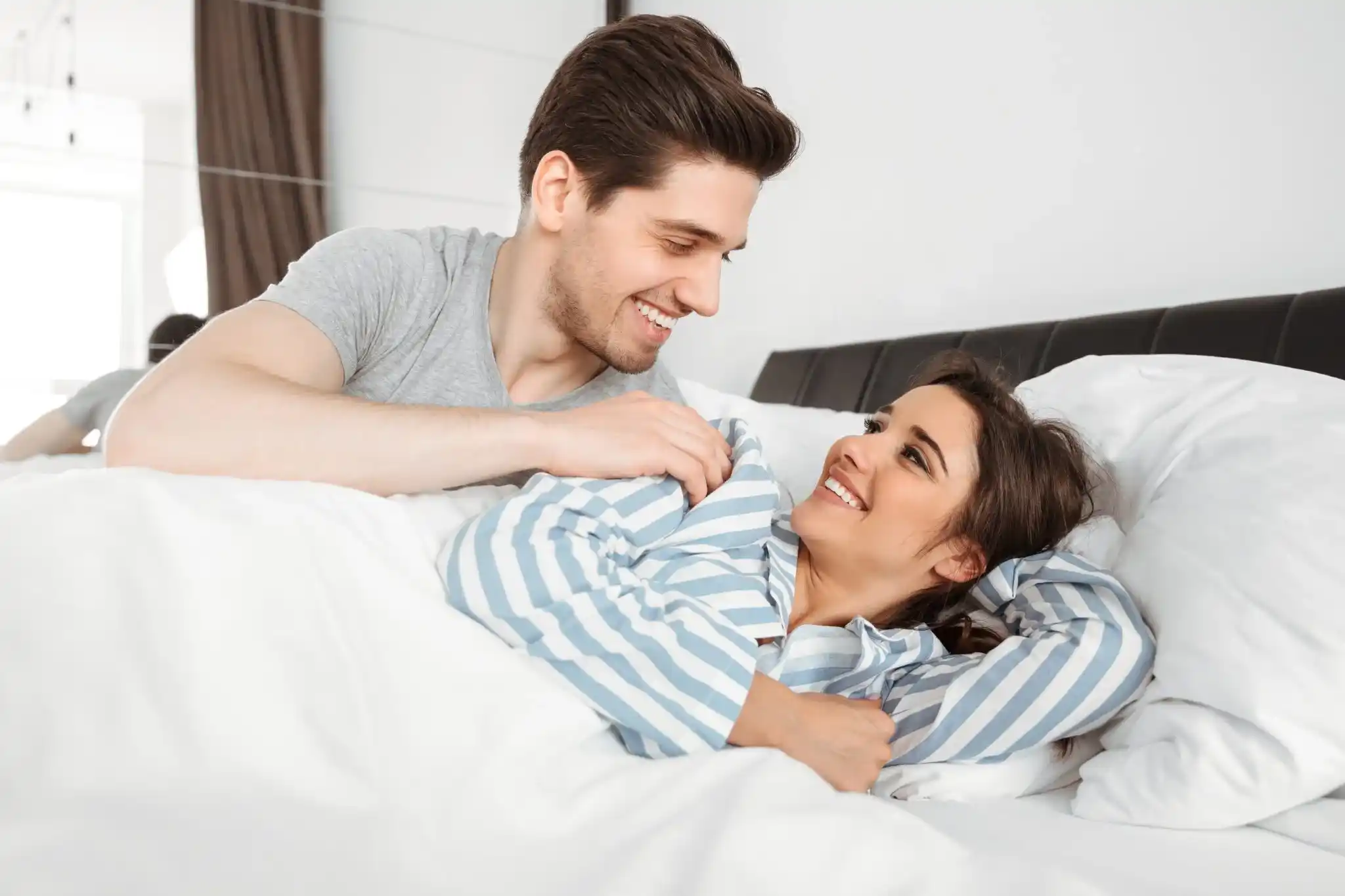 portrait cheerful young couple lying together