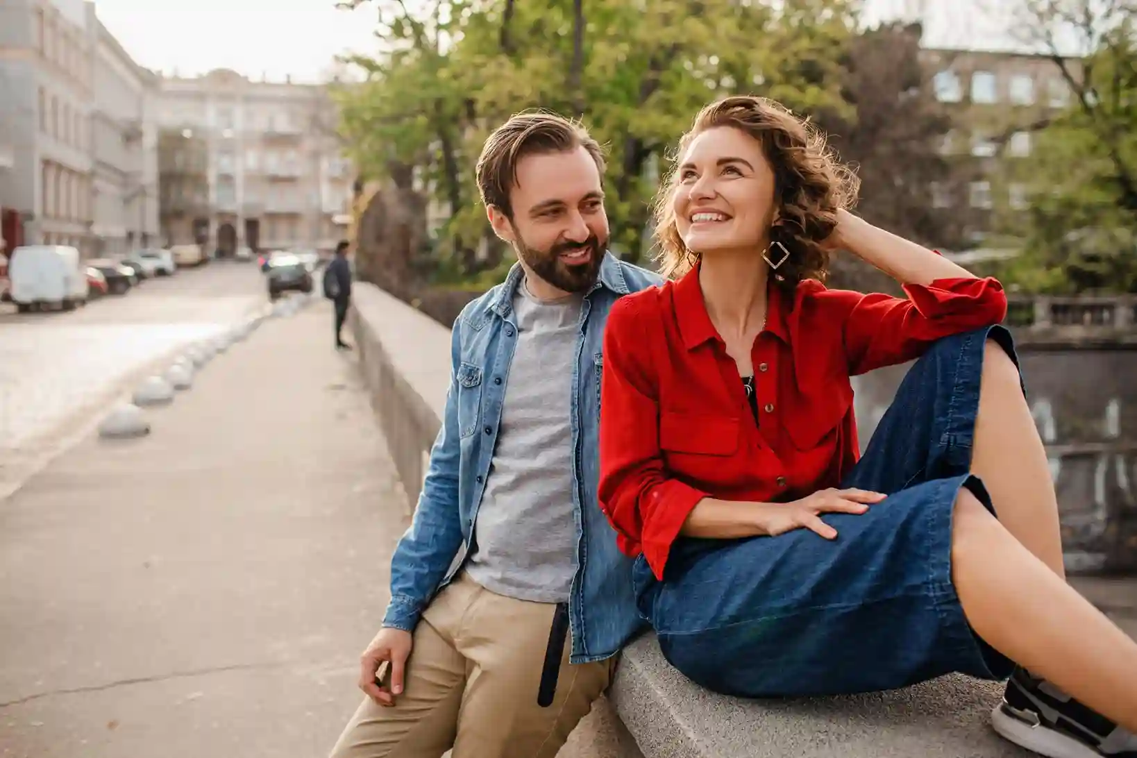 young smiling man hugging attractive happy woman